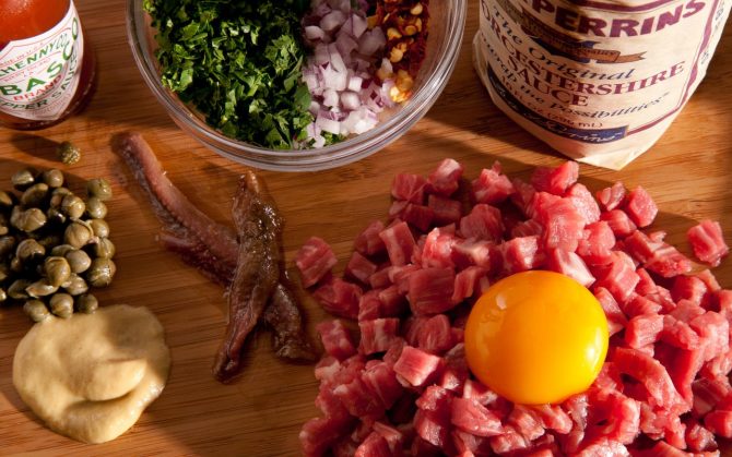 classic steak tartare with capers, onions, anchovies, and egg