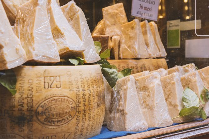 BOLOGNA, ITALY - FEBRUARY 08, 2017. Shop window display of local cheese shop selling Parmigiano Reggiano. ; Shutterstock ID 578930254; Purchase Order: ; Job: Chowhound; Client/Licensee: ; Other: