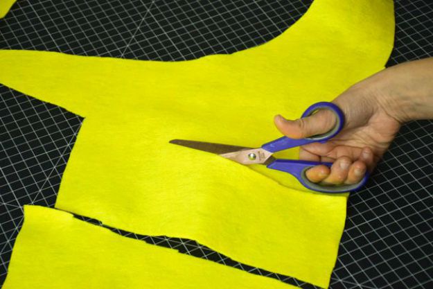 Cut strips out of yellow felt scraps to stuff minion costume | How To Make A Minion Costume | DIY Costume Plans 