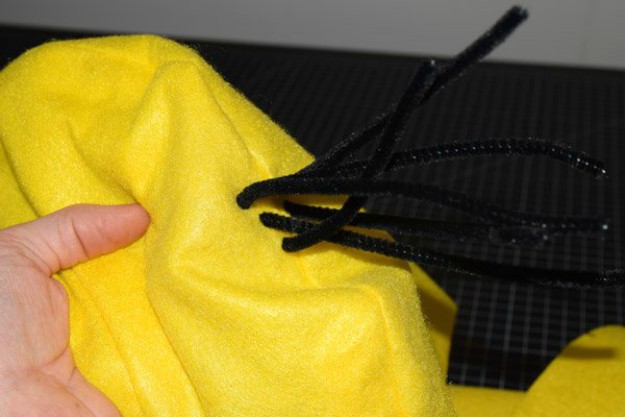 Add black pipe cleaner to minion costume for hair | How To Make A Minion Costume | DIY Costume Plans 