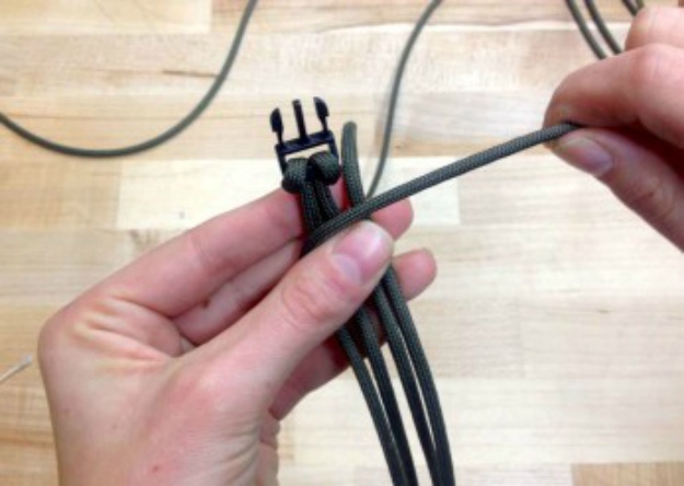 Hold the ends so the left free strand | How To Make A Paracord Bracelet: Blaze Bar Quick Deploy | how to make a paracord bracelet | paracord bracelet patterns