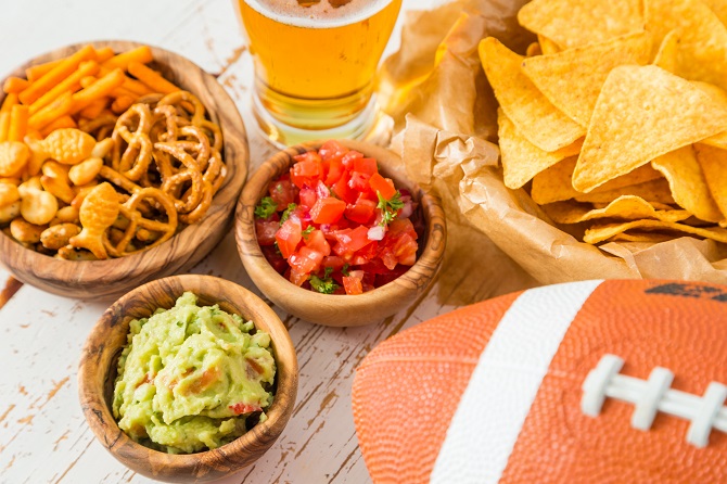 Super Bowl party food, including chips and guac and beer