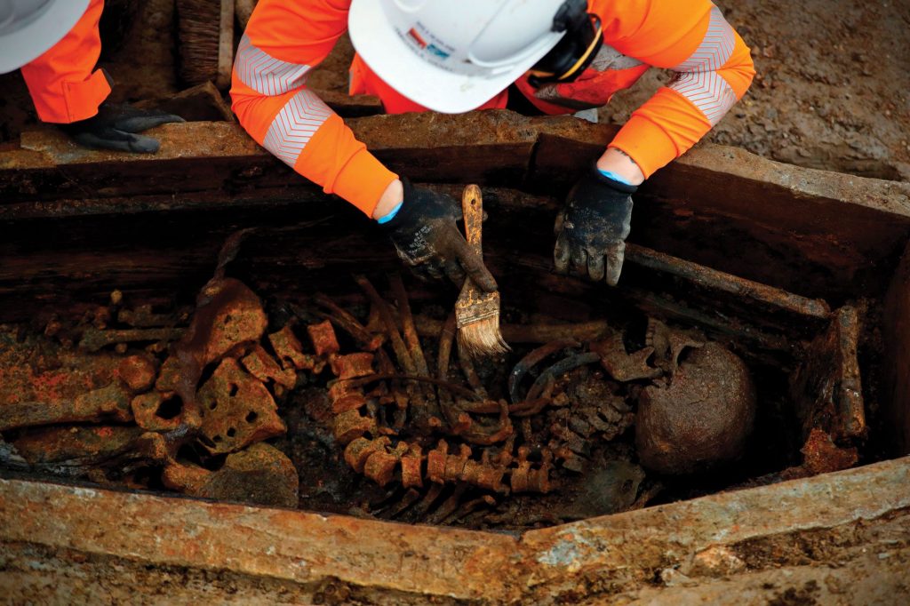 An archaeologist carefully cleans one of the thousands of bodies uncovered in St. James&rsquo;s burial ground in London.