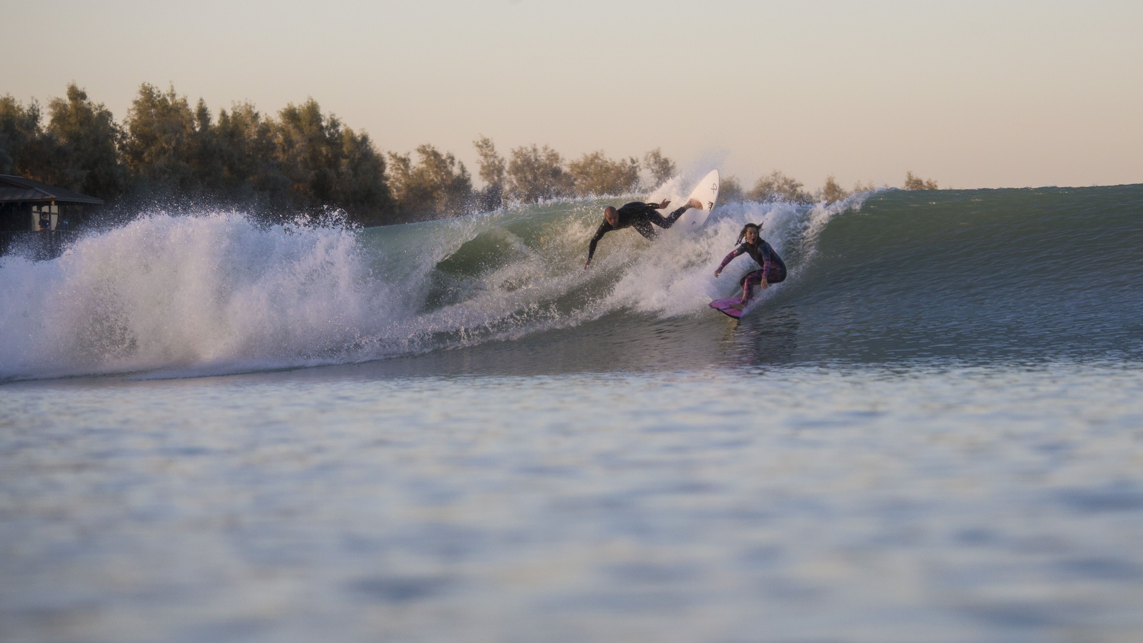 Kelly Slater (left) and Bianca Valenti test the waves at Slater's surf park in California. The facility is just one of many that have opened around the world to meet the demands of surfing and a quickly changing natural world.