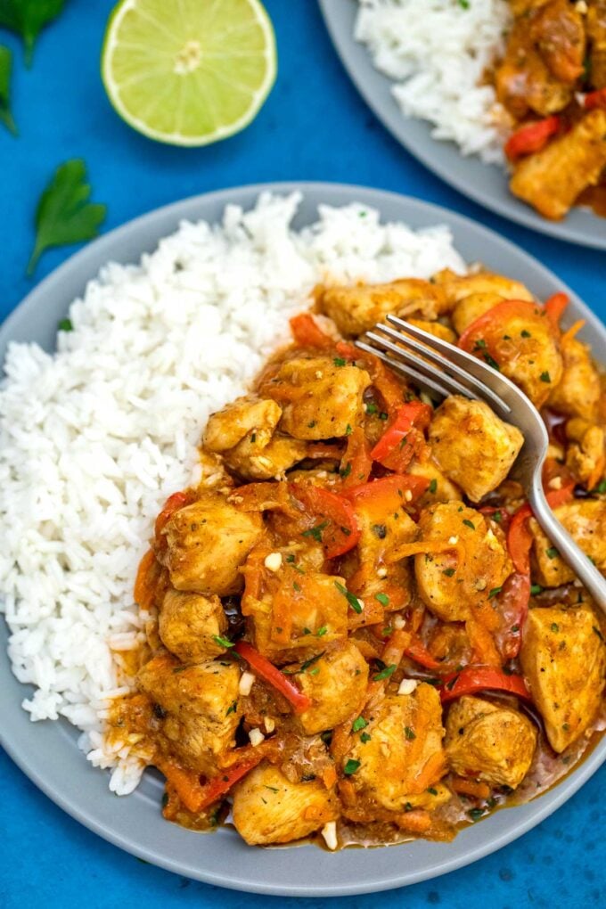 image of coconut curry chicken plated with lime on the side